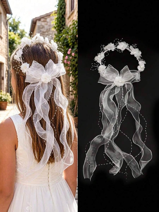 Girl wearing white floral crown communion veil with pearl ribbon and organza bow, back view outdoors