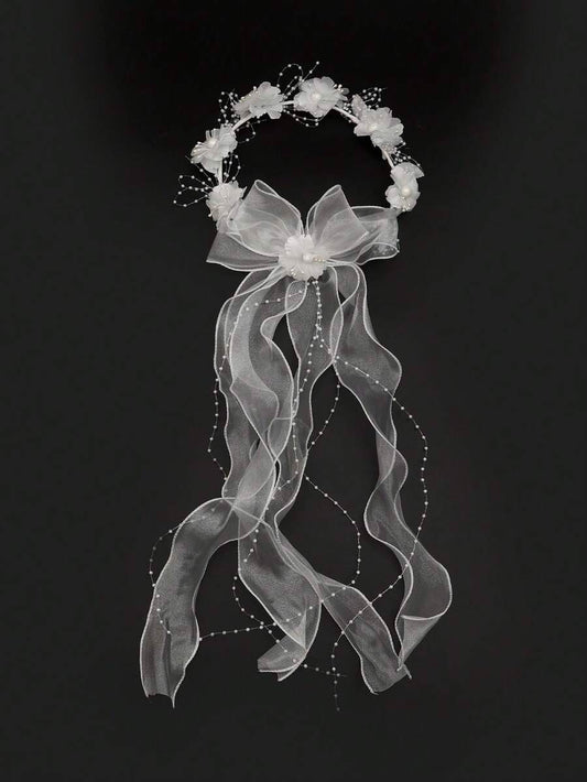 White floral crown communion veil with organza bow and pearl ribbon trails on black background