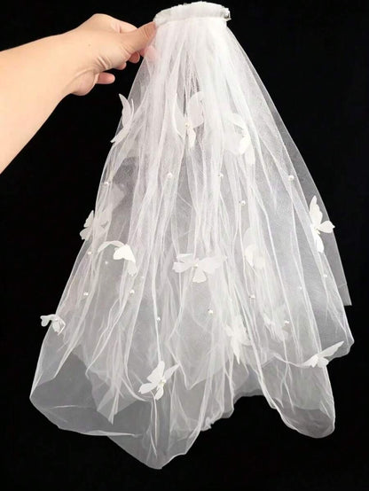 White butterfly appliqué and pearl dot communion veil on mannequin, full length view