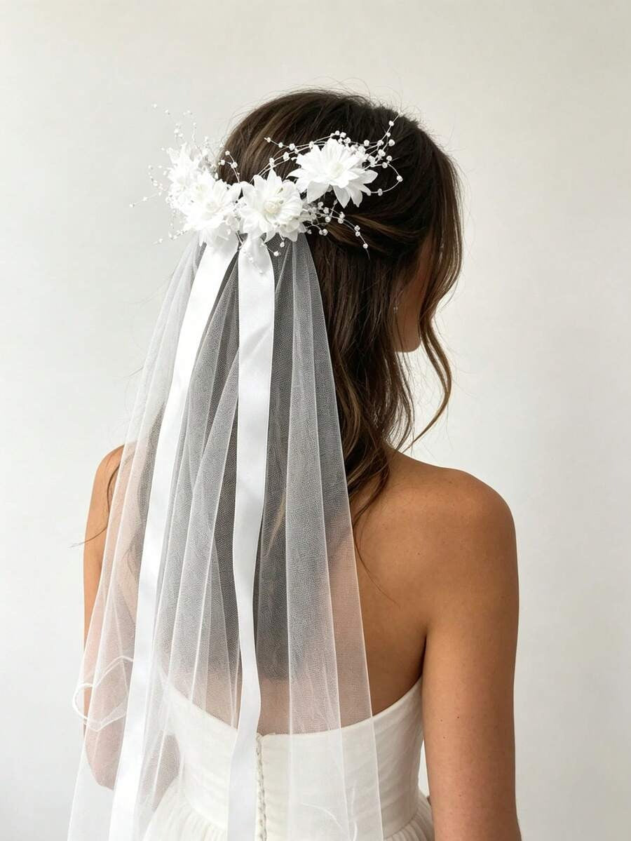 Girl wearing white floral comb communion veil with pearl sprays and satin ribbon trails, back view