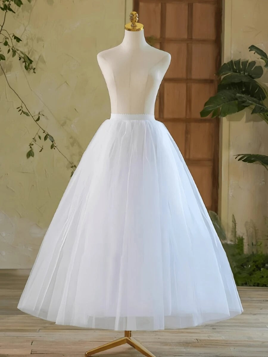 Girls white floor-length tulle petticoat on mannequin, elegant full A-line silhouette