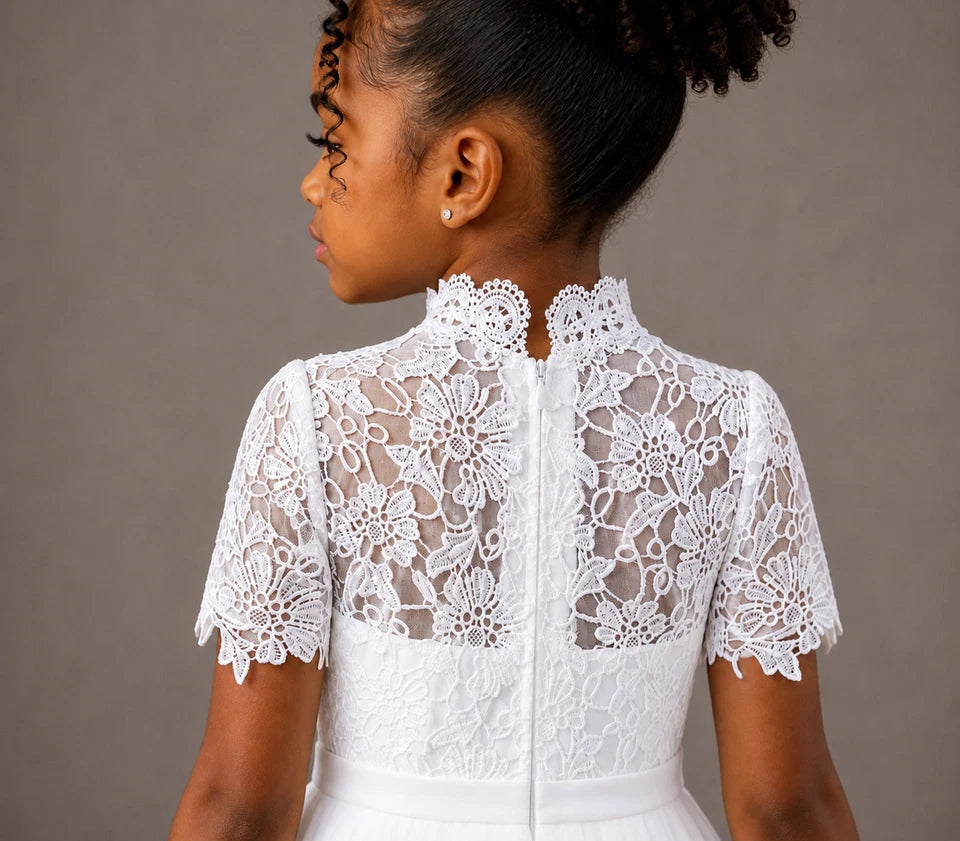 White lace dress worn by a person on a brown background
