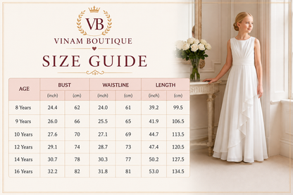 A size guide chart for Vinam Boutique dress sizes, featuring a table with age, bust, waistline, and length measurements in inches and centimeters. A young girl wearing a sleeveless white A-line dress stands beside a console table with flowers in a bright interior setting.