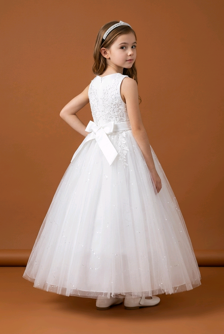 Young girl wearing a white dress with a bow on a brown background
