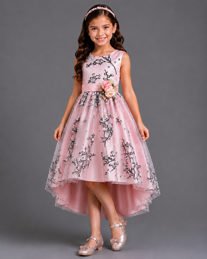 Young girl wearing a pink floral dress against a gray background