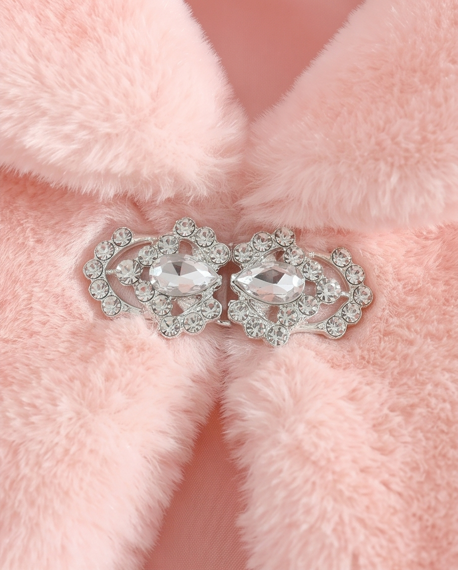 Pair of silver earrings with clear stones on a pink fur background