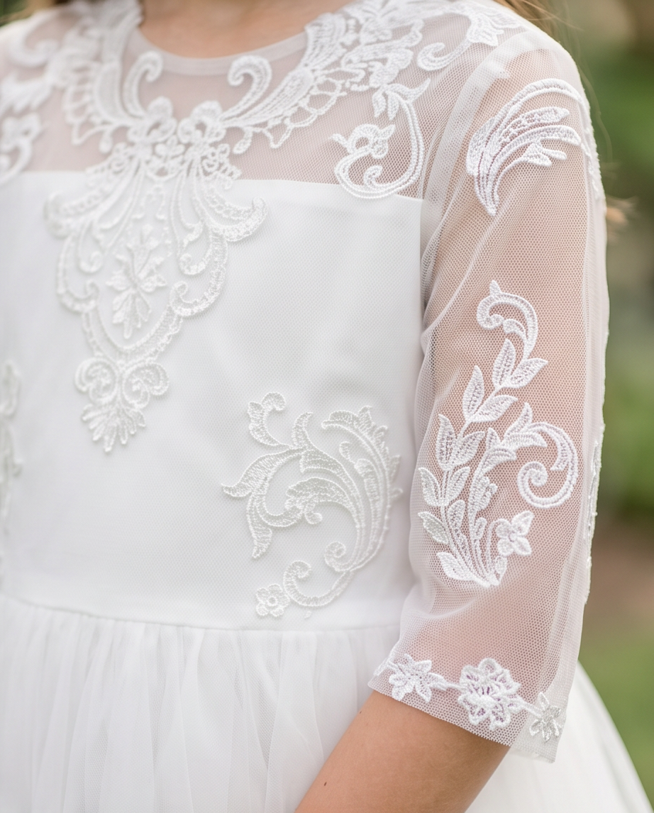 White lace dress with intricate patterns on a blurred natural background