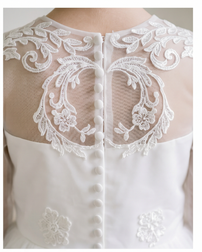 Close-up of a white lace garment with intricate designs.