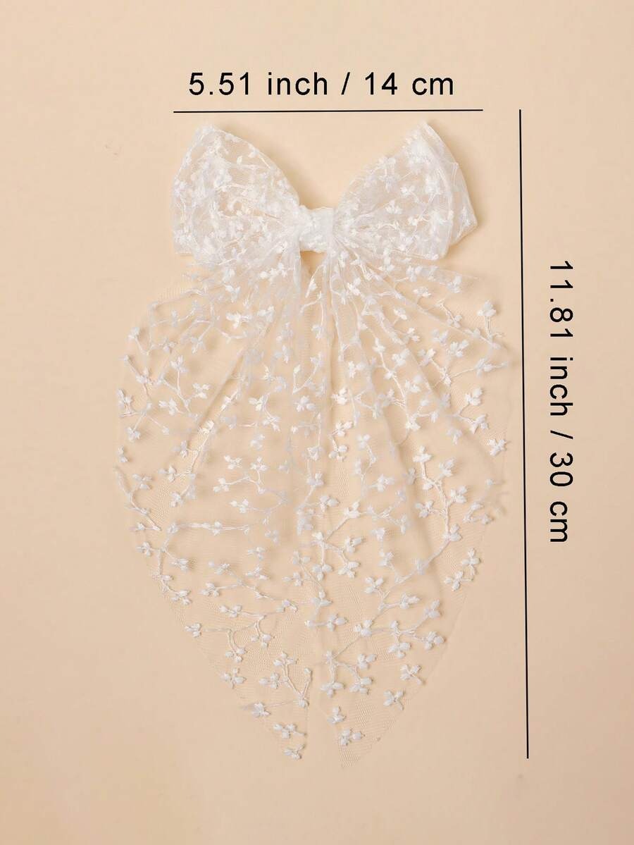 White bow with measurements on a beige background