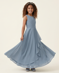 Young girl wearing a blue dress against a beige background