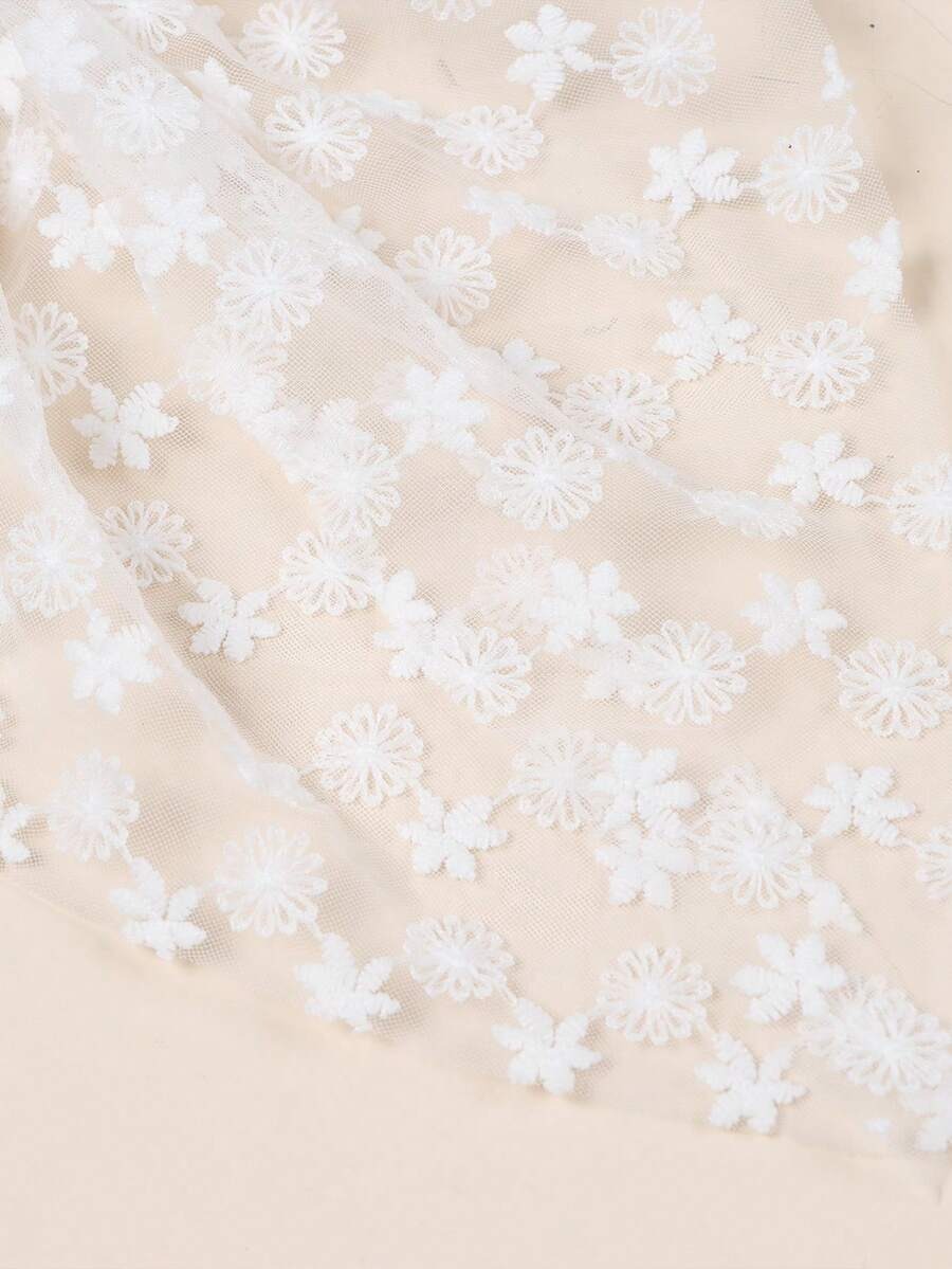 Beige fabric with white floral embroidery