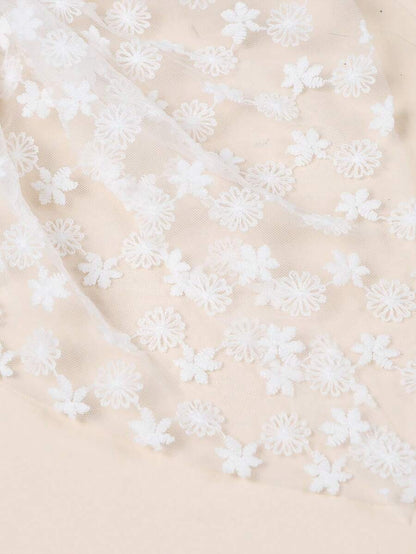 Beige fabric with white floral embroidery