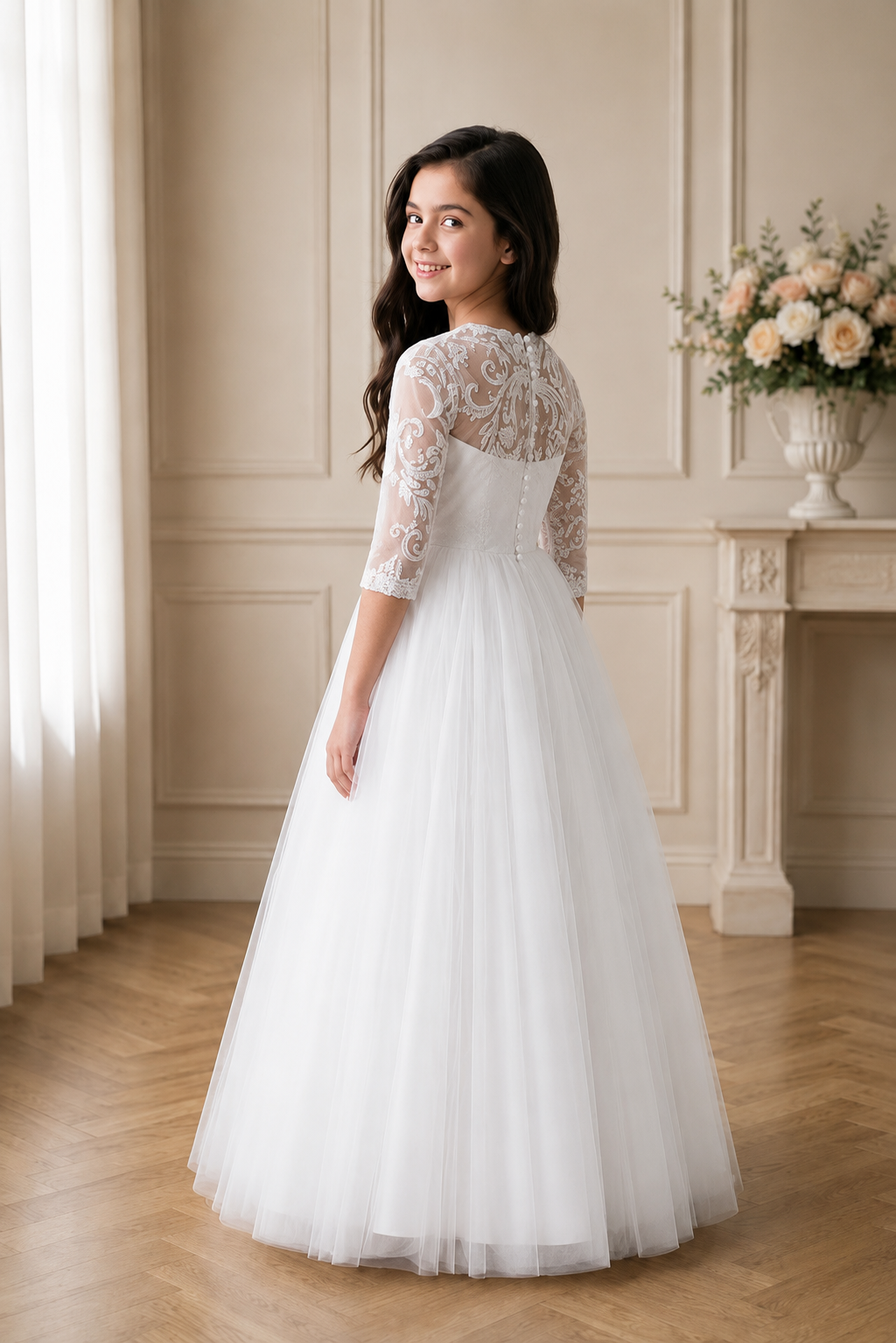 Girl in a white wedding dress with lace sleeves standing in a elegant room.