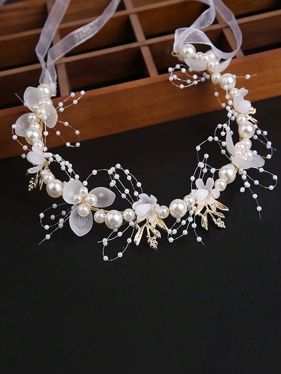 Pearl and flower hair accessory on a dark background