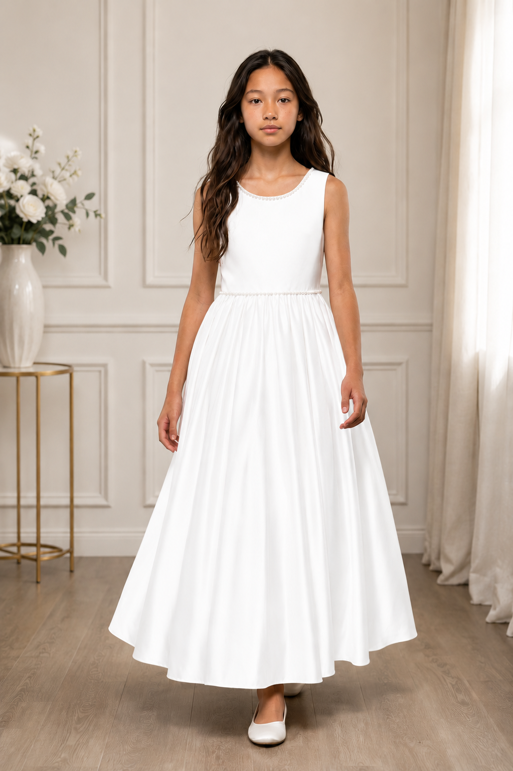 Young girl wearing a white dress in a room with neutral decor