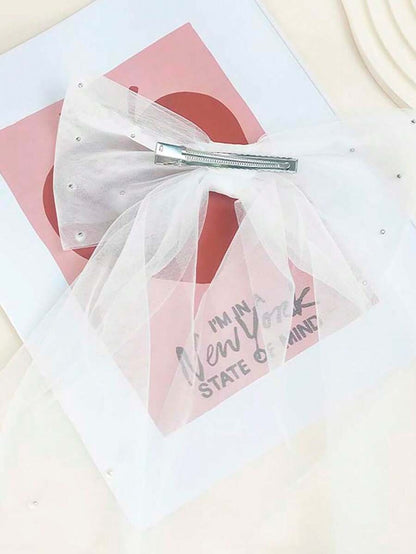 White hair bow with a pink card and text on a white background