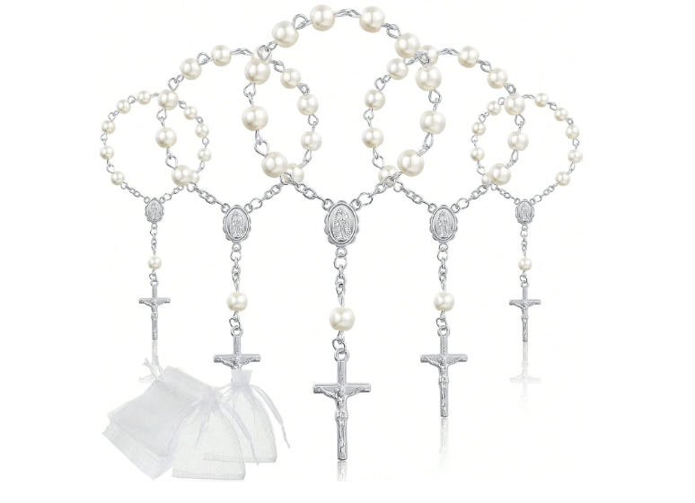 White pearl rosary bracelet placed inside white laser-cut communion gift box with cross detail on marble surface
