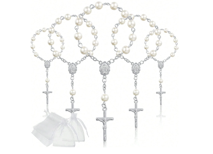 White pearl rosary bracelet placed inside white laser-cut communion gift box with cross detail on marble surface