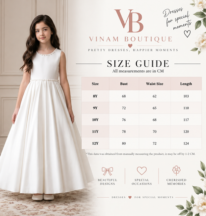 A size guide infographic for Vinam Boutique featuring a young girl modeling a sleeveless white A-line dress, alongside a detailed measurement table from 8Y to 12Y. The graphic includes the brand logo 'VB' and decorative floral elements on a warm beige background.