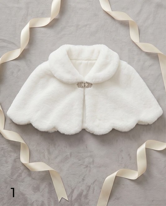 White fur shrug with a brooch on a gray background with ribbons