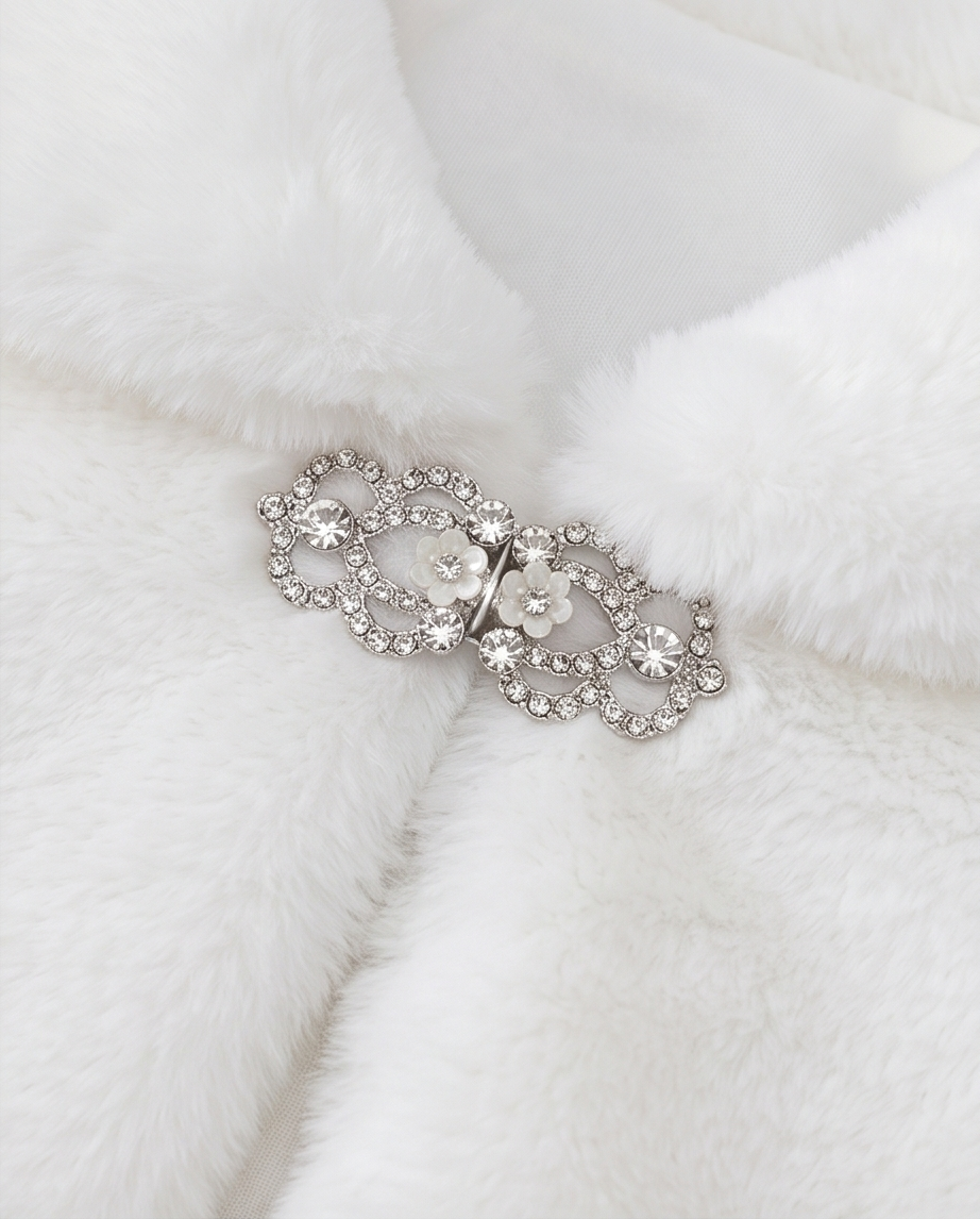 Silver brooch with gemstones on a white fur background