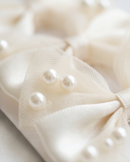 Close-up of a cream-colored fabric with pearl-like embellishments