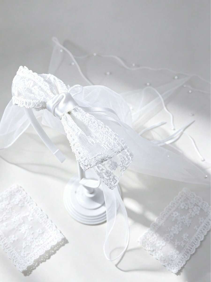 White lace veil with a bow on a light gray background