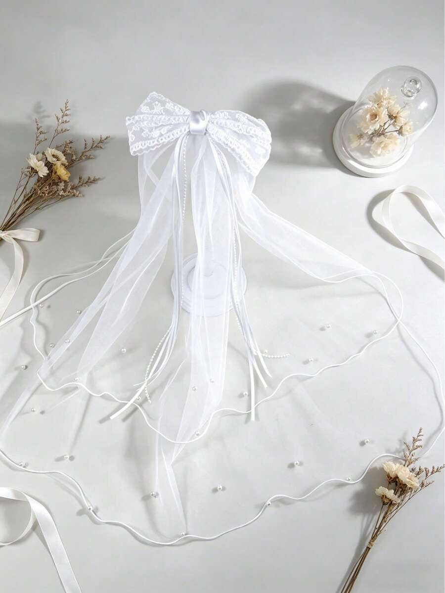 White veil with a bow on a light gray background